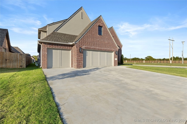 view of front of property with a front yard and a garage