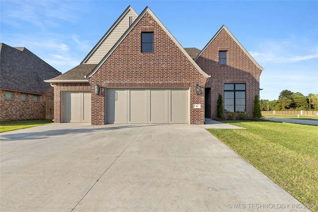 view of front of house featuring a garage and a front lawn