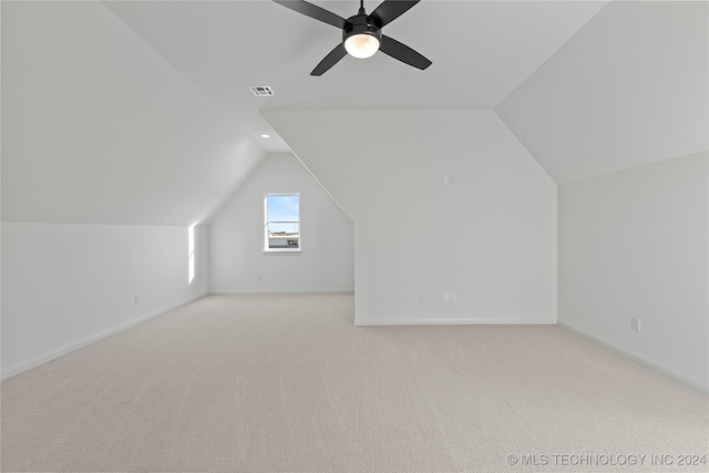 bonus room featuring ceiling fan, light colored carpet, and vaulted ceiling