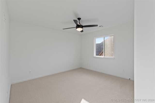 spare room with light carpet and ceiling fan