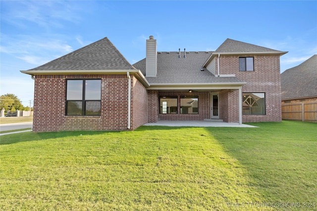 back of house featuring a yard and a patio