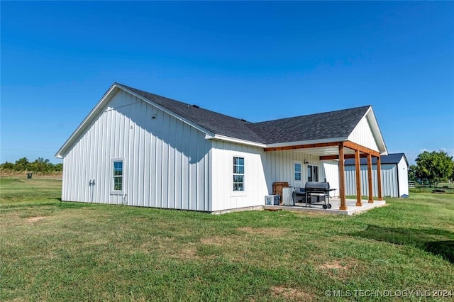 rear view of property with a patio and a yard