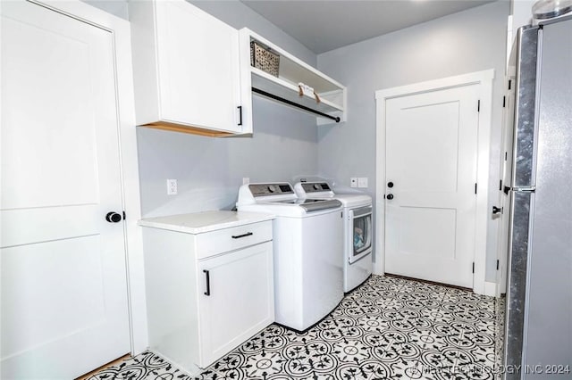 laundry area featuring cabinets and independent washer and dryer