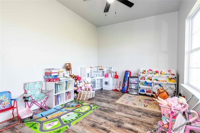 game room with hardwood / wood-style floors, ceiling fan, and plenty of natural light