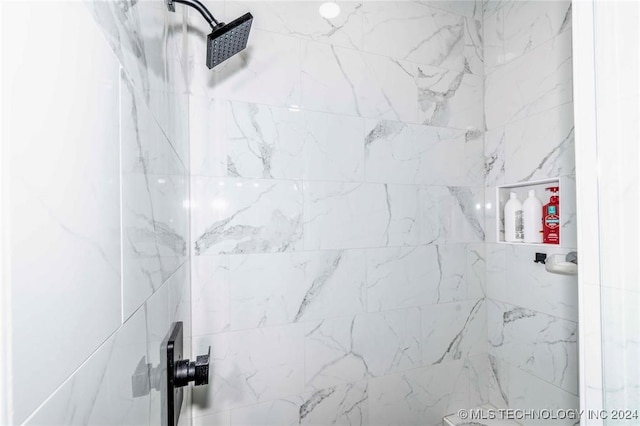 bathroom with a tile shower