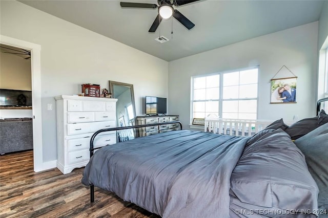 bedroom with ceiling fan and dark hardwood / wood-style flooring