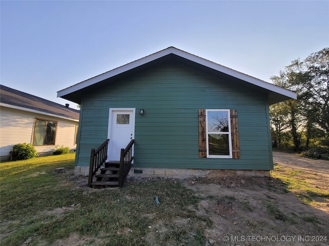 back of house with a lawn