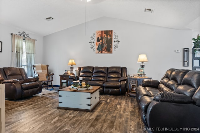 living room featuring lofted ceiling and dark hardwood / wood-style floors