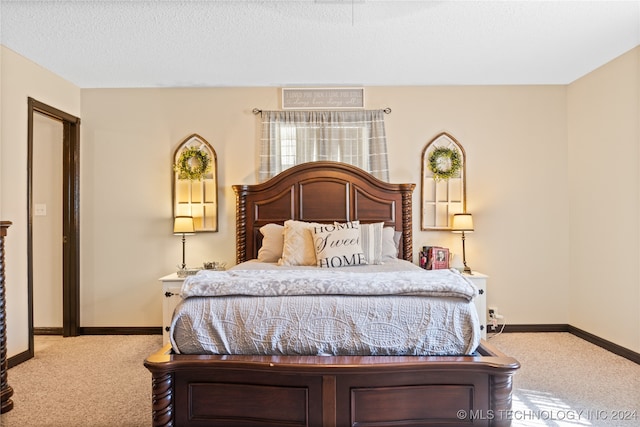 bedroom featuring a textured ceiling and carpet floors