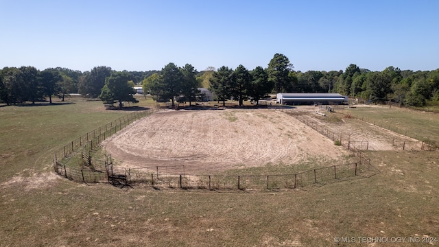 exterior space featuring a rural view and a yard