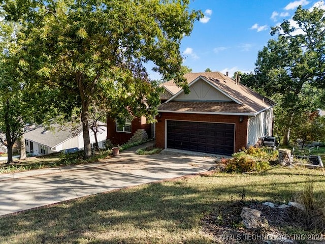 view of front of house with a garage and a front lawn