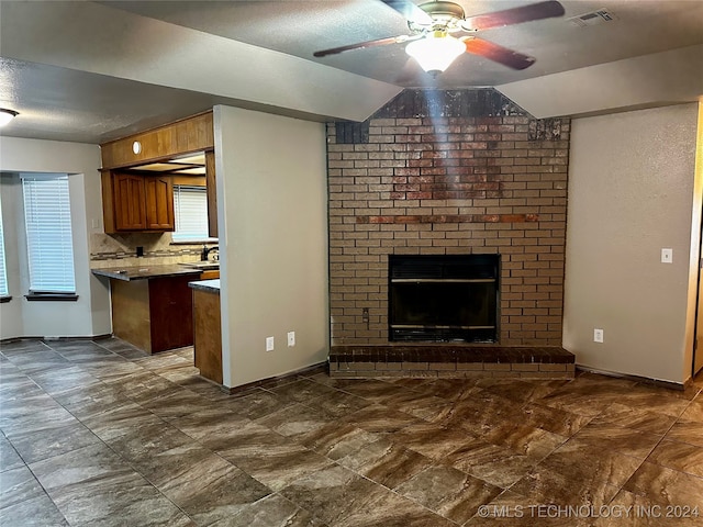 unfurnished living room with lofted ceiling, a fireplace, and ceiling fan