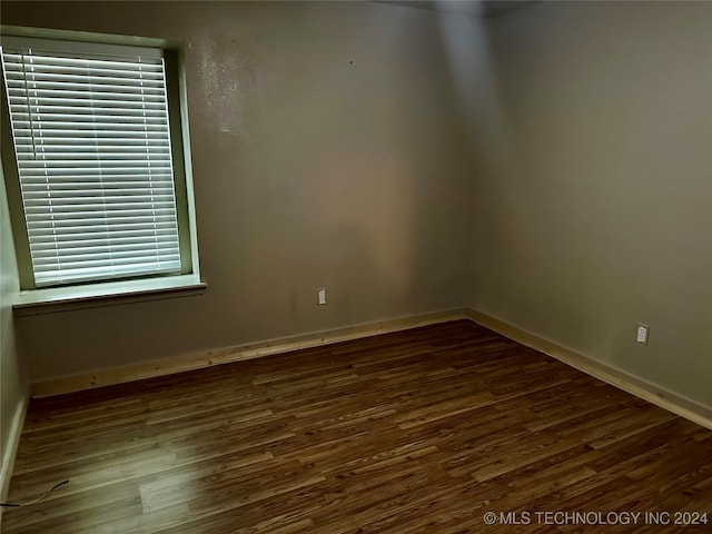 spare room with dark wood-type flooring