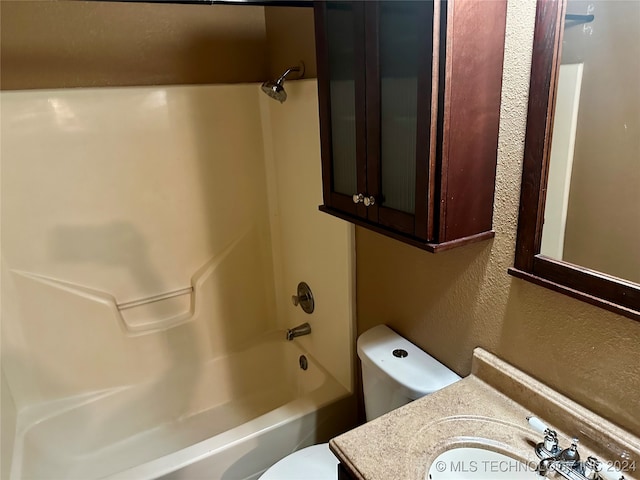 full bathroom featuring vanity, bathing tub / shower combination, and toilet