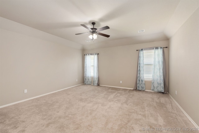 empty room with ceiling fan and light colored carpet