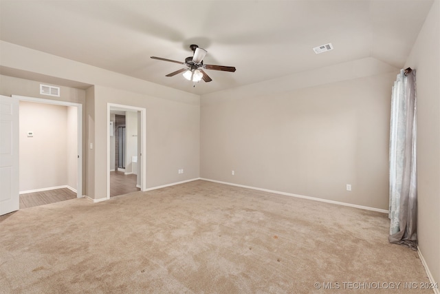 carpeted empty room with lofted ceiling and ceiling fan