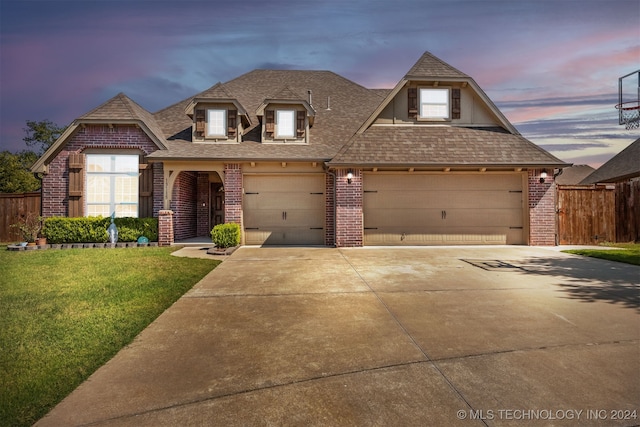 view of front of home featuring a garage and a lawn