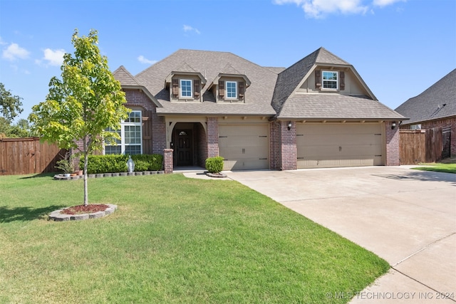 view of front of property with a garage and a front lawn