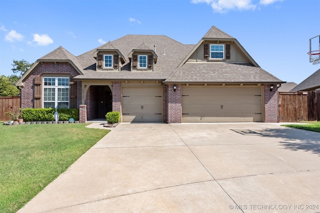 view of front of property with a garage and a front lawn