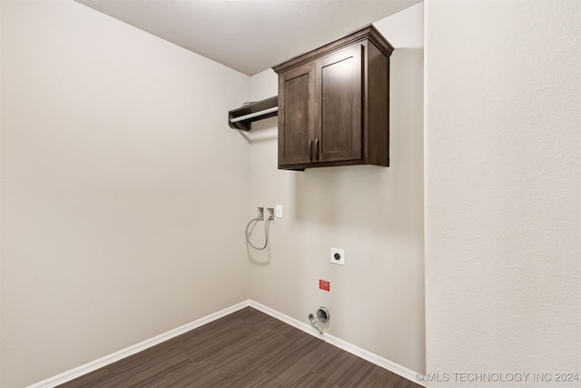 laundry room with a textured ceiling, cabinets, dark hardwood / wood-style floors, hookup for a washing machine, and electric dryer hookup