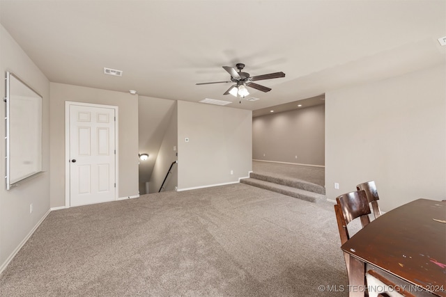 carpeted spare room with ceiling fan