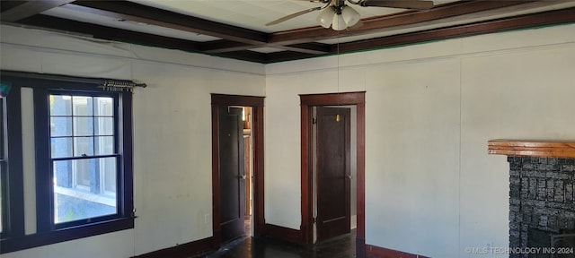 spare room with coffered ceiling, beam ceiling, and ceiling fan