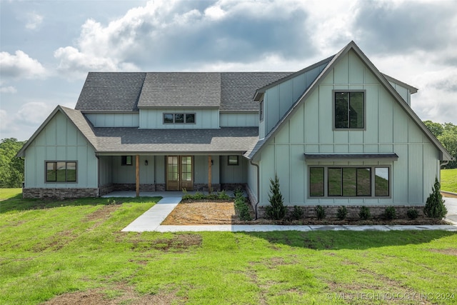 view of front of home with covered porch and a front yard