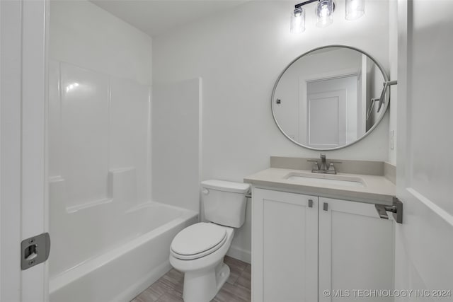 full bathroom with vanity, bathing tub / shower combination, toilet, and hardwood / wood-style flooring