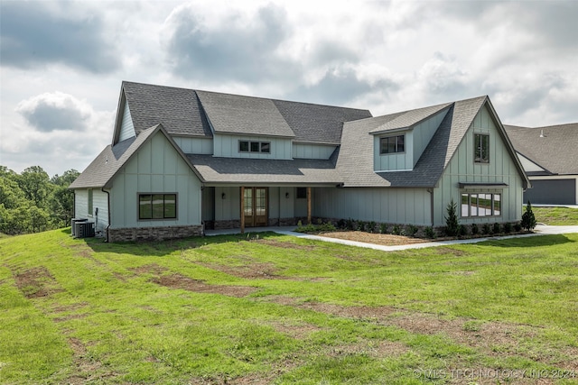 view of front of home featuring cooling unit and a front lawn