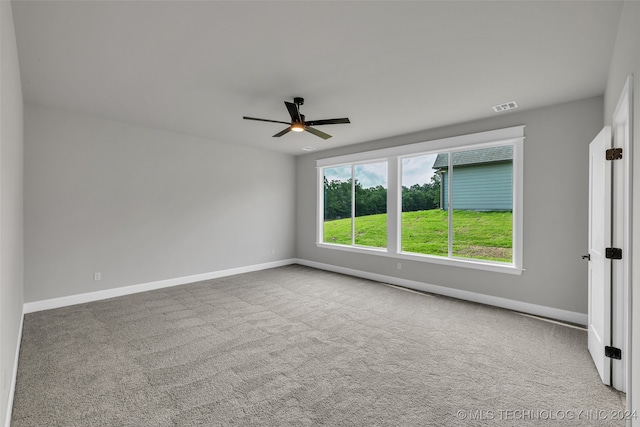 empty room featuring carpet floors and ceiling fan