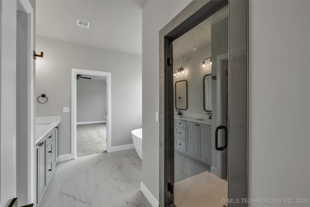 bathroom featuring shower with separate bathtub and vanity