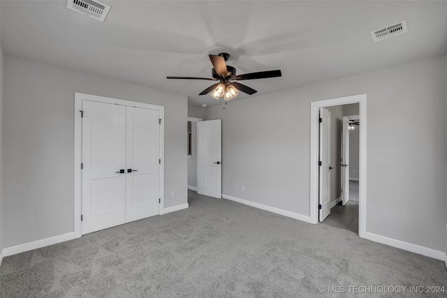 unfurnished bedroom featuring light carpet, ceiling fan, and a closet