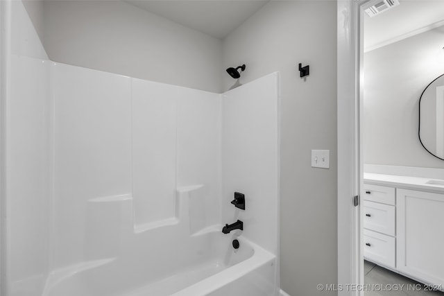 bathroom featuring tile patterned floors, shower / washtub combination, and vanity