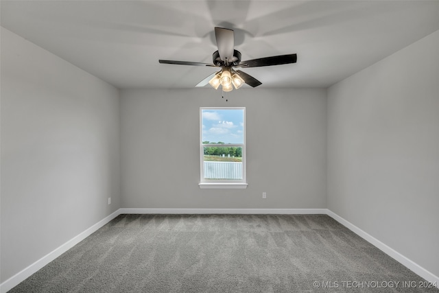 unfurnished room with ceiling fan and carpet