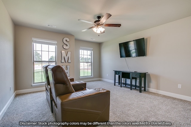 carpeted living room featuring ceiling fan and a wealth of natural light