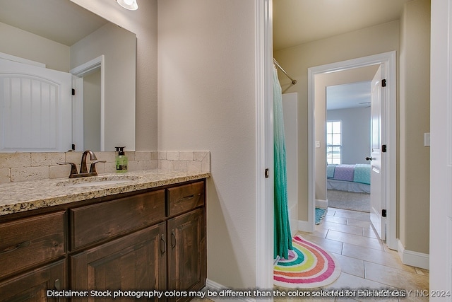 bathroom featuring tile patterned flooring, vanity, and a shower with curtain