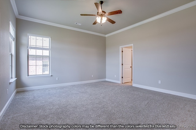 spare room featuring ornamental molding, ceiling fan, and light carpet