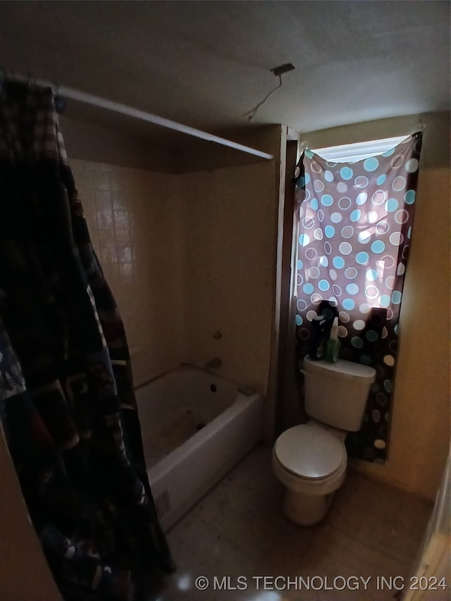 bathroom featuring toilet and shower / bath combo