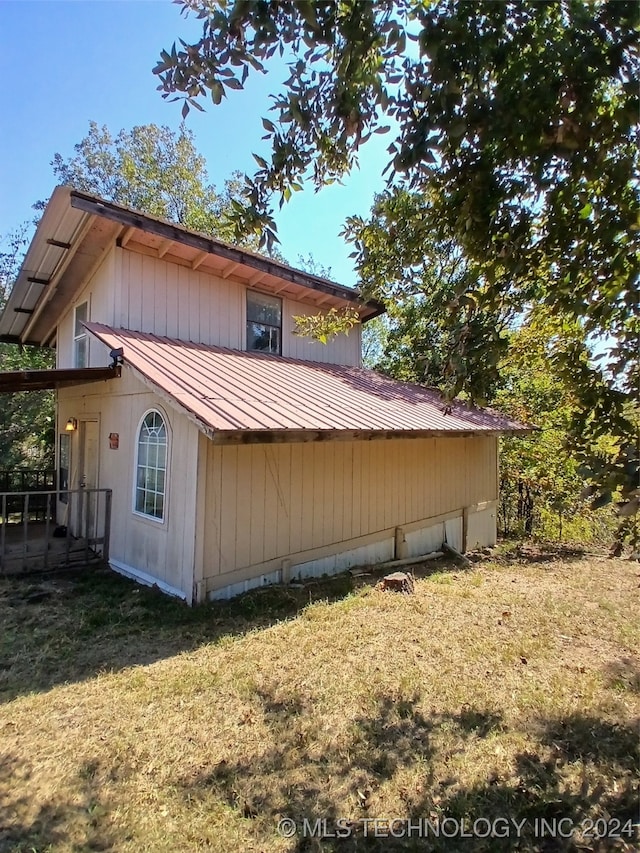 view of property exterior featuring a lawn