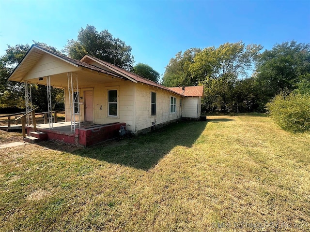 exterior space featuring a porch and a lawn