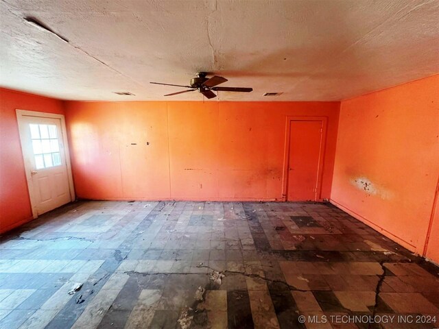1721 Bighill Ave, Pawhuska, OK 74056 - empty room with a ceiling fan and a textured ceiling