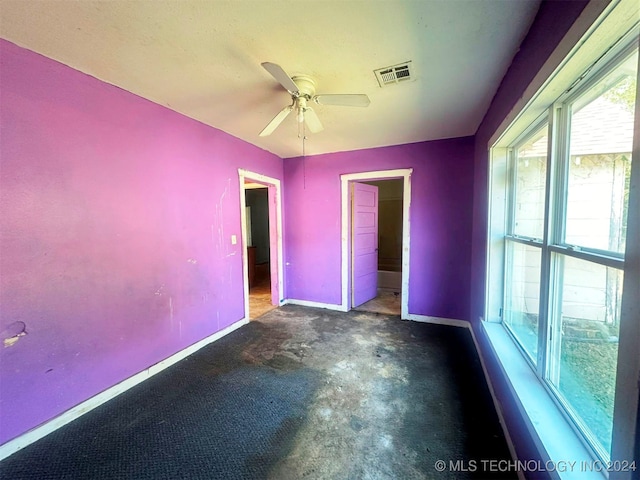 unfurnished bedroom with a spacious closet, ceiling fan, and a closet