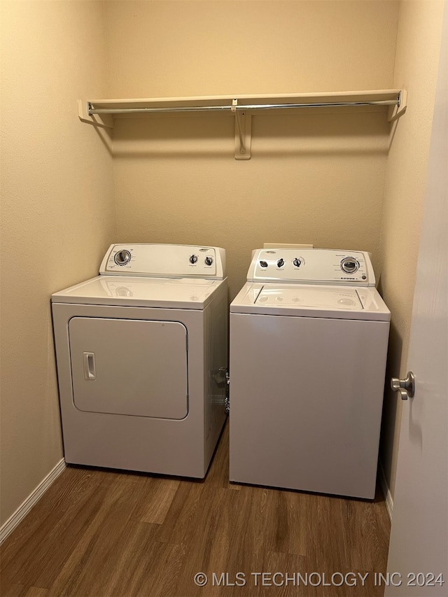 laundry room featuring independent washer and dryer and dark hardwood / wood-style flooring