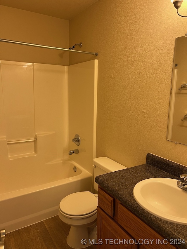 full bathroom featuring wood-type flooring, vanity, toilet, and shower / washtub combination