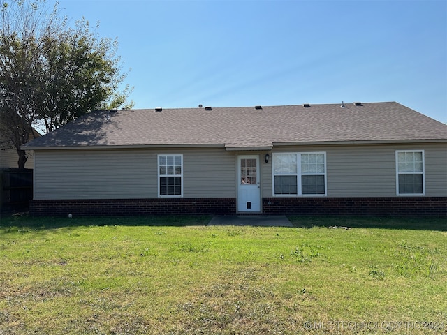 back of property with a lawn