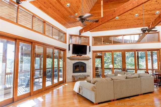 living area with wooden ceiling, ceiling fan, high vaulted ceiling, and french doors