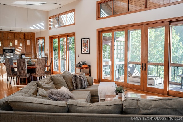 living room featuring a high ceiling and wood finished floors