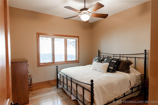 bedroom featuring ceiling fan, wood finished floors, and baseboards