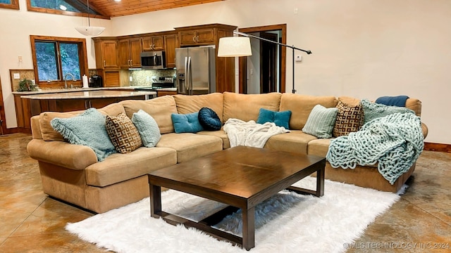 living area with high vaulted ceiling, wooden ceiling, and baseboards