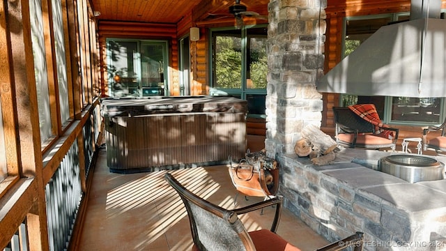 exterior space with wood ceiling and a hot tub